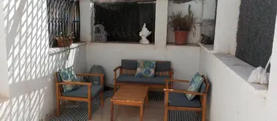a porch with two chairs and a table and chairs at Atico En El Centro in Valencia