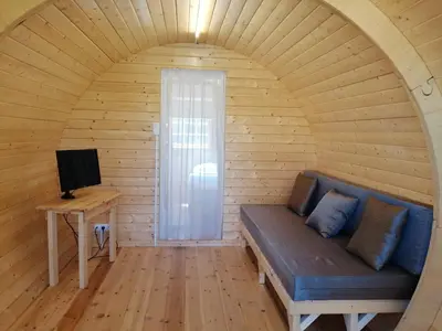 a room with a couch and a television in a room at Camping-Bungalows Altomira in Navajas