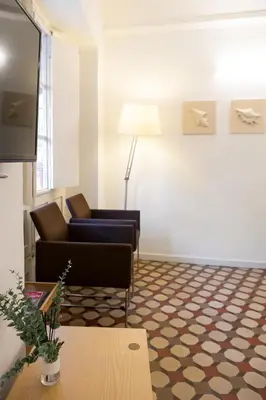 a living room with two chairs and a flat screen tv at San Jaime Silence in Valencia