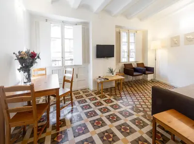 a living room with a table and chairs and a couch at San Jaime Silence in Valencia