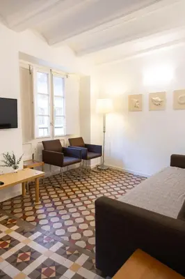 a living room with a bed and a couch at San Jaime Silence in Valencia