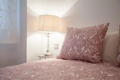 a bedroom with a bed with a pillow and a lamp at Hi Valencia Apartments - Jorge Juan in Valencia