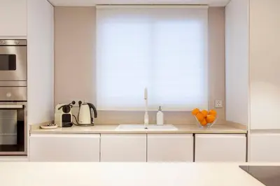 a kitchen with a sink and a window with oranges at Hi Valencia Apartments - Jorge Juan in Valencia