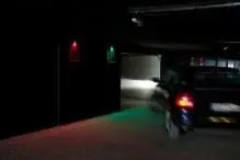 a car driving down a street at night with a traffic light at Shhh in Onda