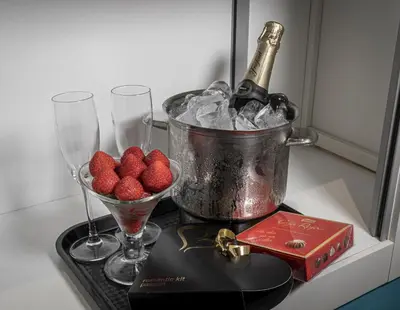 a bucket of ice and two wine glasses and strawberries at Shhh in Onda