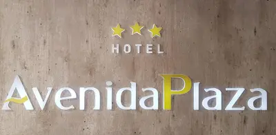 a sign for a hotel with stars on a wall at Hotel Avenida Plaza in Alzira