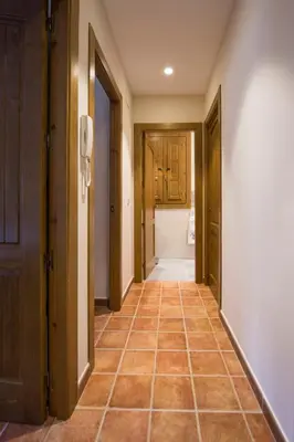 a hallway with doors and a tile floor at Casa Rural Francisca in Requena