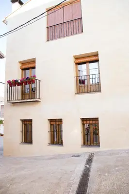 a white building with windows and flower boxes at Casa Rural Francisca in Requena