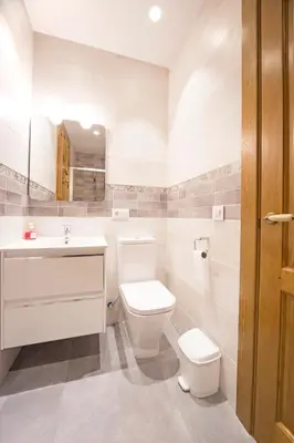a white bathroom with a toilet and a sink at Casa Rural Francisca in Requena