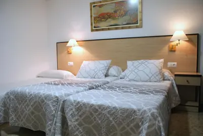 a hotel room with two beds next to each other at Hotel Carabela 2 in Cullera