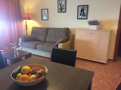 a living room with a bowl of fruit on a table at Florazar de Ensueño in Cullera