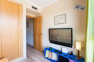 a room with a flat screen tv on a wall at Biopark View Apartment in Valencia