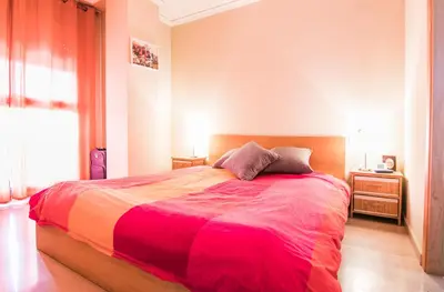a bedroom with a large bed with a colorful blanket at Biopark View Apartment in Valencia