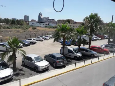 a bunch of cars parked in a parking lot at Biopark View Apartment in Valencia