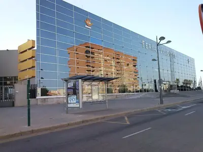 a bus stop in front of a large glass building at Hostal Mitre Paterna in Paterna