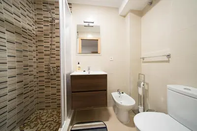 a bathroom with a toilet and a sink at Hostal Mitre Paterna in Paterna