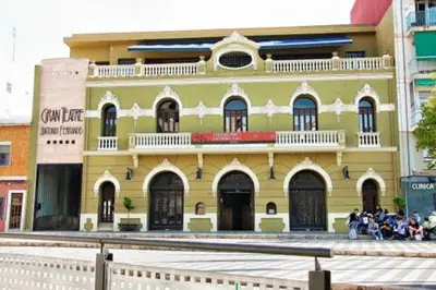 a yellow building with people standing in front of it at Hostal Mitre Paterna in Paterna