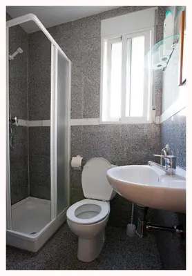 a bathroom with a toilet and a sink at Hostal Mitre Paterna in Paterna