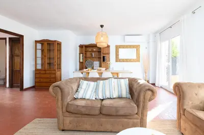 a living room with a couch and a table at Travel Habitat Casa con embarcadero. in Port Saplaya
