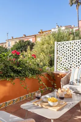 a table with food and drinks on a patio at Travel Habitat Casa con embarcadero. in Port Saplaya