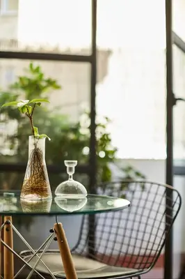 a glass table with a glass vase and a vase at Bubusuites in Valencia