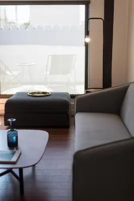 a living room with two couches and a table at Bubusuites in Valencia