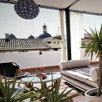 a balcony with a couch and a table at MD Design Hotel - Portal del Real in Valencia