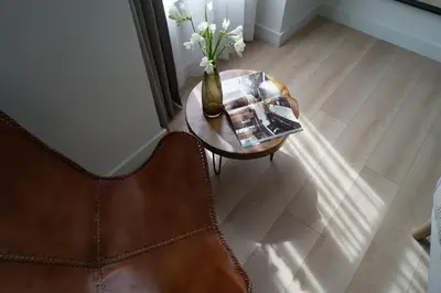 a vase of flowers on a table with a chair at MD Design Hotel - Portal del Real in Valencia
