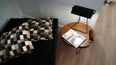 a black couch with checkered pillows and a table at MD Design Hotel - Portal del Real in Valencia