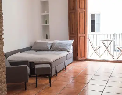 a bed sitting on a tiled floor in a room at Ambrosio Flats Valencia - El Carmen in Valencia