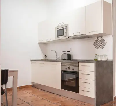 a kitchen with white cabinets and a microwave at Ambrosio Flats Valencia - El Carmen in Valencia
