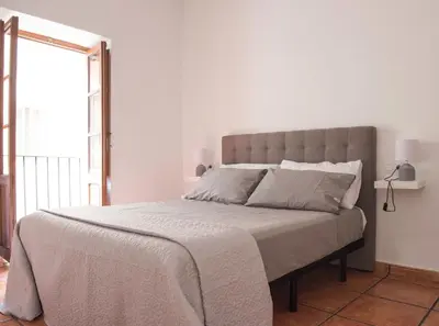 a bedroom with a large bed with a large window at Ambrosio Flats Valencia - El Carmen in Valencia
