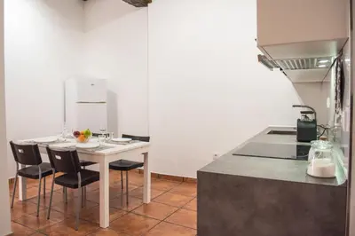 a kitchen with a table and chairs in a room at Ambrosio Flats Valencia - El Carmen in Valencia