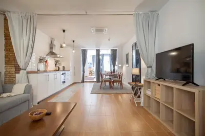 a living room with a couch and a tv at Habana Apartment in Valencia