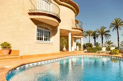 a house with a swimming pool in front of a building at MD Villa Cullera Cap Blanc in Faro de Cullera