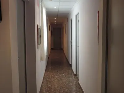 a long hallway with white walls and a long hallwayngthngthngthngth at Hotel Costa San Antonio in Cullera