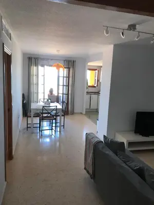 a living room with a couch and a table at Apartamento PortSaplaya in Port Saplaya