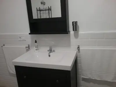 a bathroom with a white sink and a mirror at New Trendy apartment in Valencia
