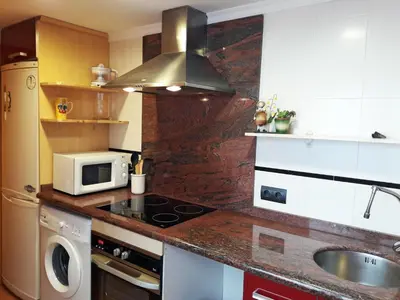 a kitchen with a stove and a microwave at Casa Cabanyal in Valencia