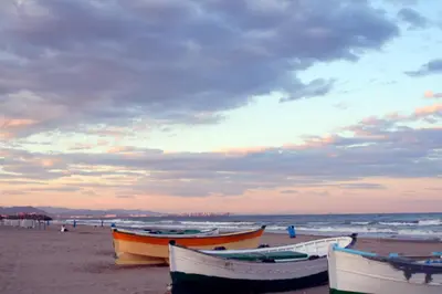 a group of boats sitting on the beach at Casa Cabanyal in Valencia