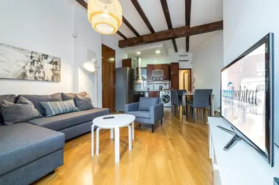 a living room with a couch and a table at Travel Habitat Jardines Rio Turia. in Valencia