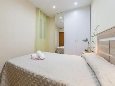 a bedroom with a bed with two towels on it at Travel Habitat Jardines Rio Turia. in Valencia
