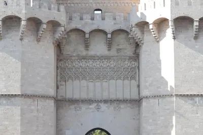 a large building with an arch in the side of it at Travel Habitat Jardines Rio Turia. in Valencia