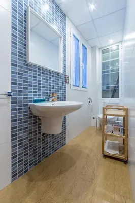 a bathroom with a sink and a mirror at Travel Habitat Jardines Rio Turia. in Valencia