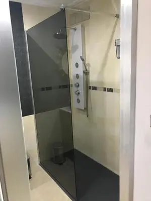 a shower with a glass door in a bathroom at Attic Valencia Beach in Valencia