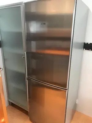a stainless steel refrigerator in a kitchen at Attic Valencia Beach in Valencia