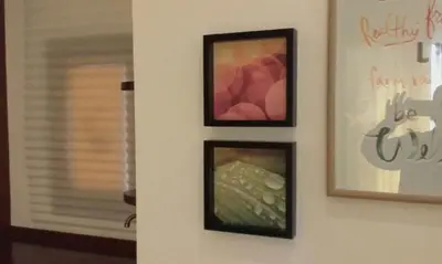 three framed pictures on a wall with a window at El Globo in Valencia