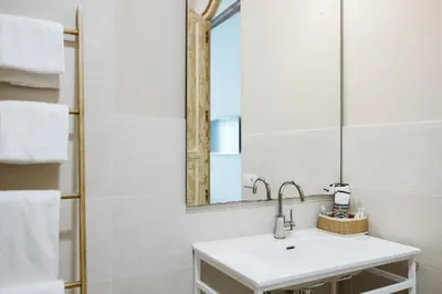 a bathroom with a sink and a mirror at OttoH Charm Stay in Valencia