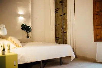 a bedroom with a bed with a plant on the wall at OttoH Charm Stay in Valencia