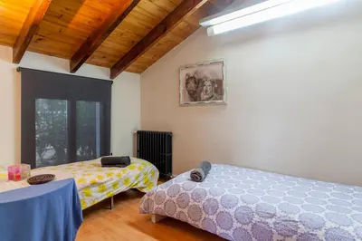 a bedroom with two beds and a window at Ca Carmela casa con Encanto con Piscina 